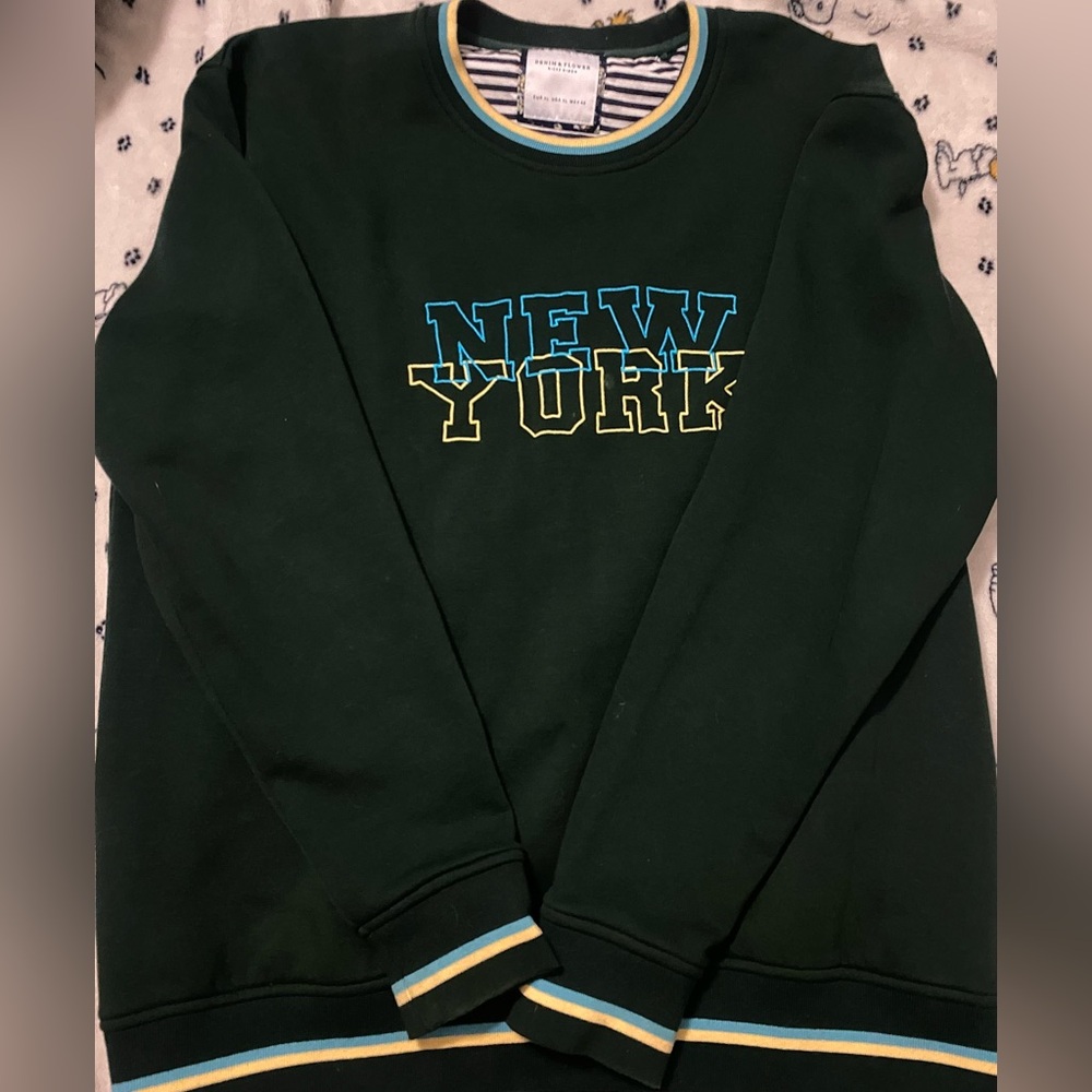 oversized dark green new york sweater with blue and yellow trim